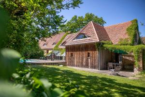 a wooden house with a pool and a yard at Feriengut Welzin in Welzin