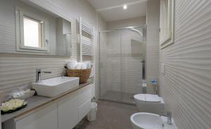 a bathroom with a toilet and a sink and a shower at B&B Civico 11 in Veglie