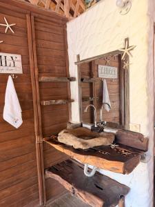 a bathroom with a sink and a mirror at Cabaña con Deck Frente al Mar para 8 personas in Moñitos +14 photos