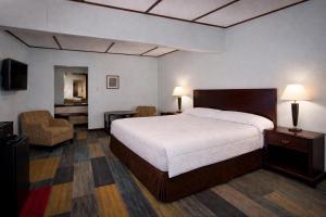 a hotel room with a bed and a chair at St Croix Suites - St Croix Falls in Saint Croix Falls +43 photos