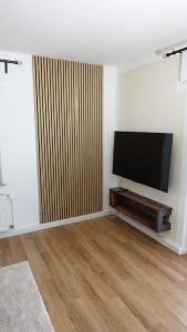 a living room with a flat screen tv on a wall at FeWo Kalletal in Kalletal