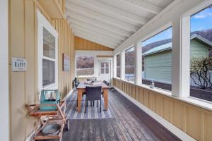 a porch with a table and chairs and windows at Sunny Getaway at Veranda Beach in Oroville
