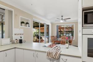 a kitchen with white cabinets and a counter top at Lemon Tree Getaway Inn in Lemon Tree Passage