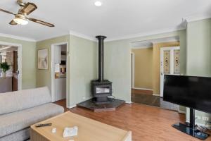 a living room with a couch and a stove at Lemon Tree Getaway Inn in Lemon Tree Passage