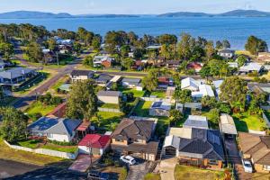 an aerial view of a suburb with houses and the water at Lemon Tree Getaway Inn in Lemon Tree Passage