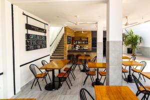a row of tables and chairs in a restaurant at Arbor Boutique Stay in Brufut