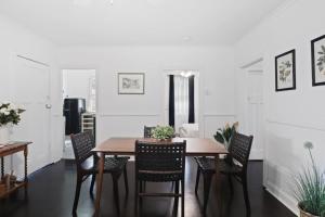 a dining room with a wooden table and chairs at Mildas Cottage Hunter Valley in Cessnock +5 photos