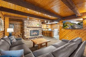 a living room with a couch and a fireplace at The Hailey Cabin in Island Park