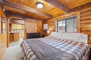 a bedroom with a bed in a wooden cabin at The Hailey Cabin in Island Park