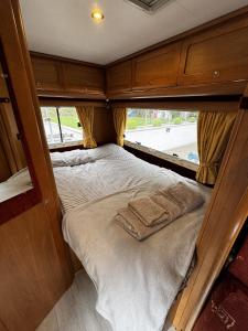 a small bed in the back of an rv at Rover Rentals in Inverness