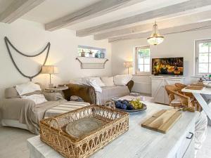 a living room with a couch and a table at Henye holiday homes in Balatonhenye