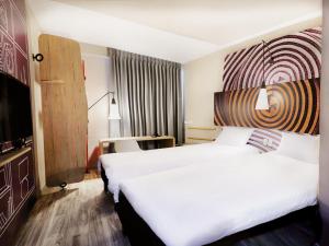 a hotel room with two beds and a tv at ibis Apartado in Apartadó +63 photos