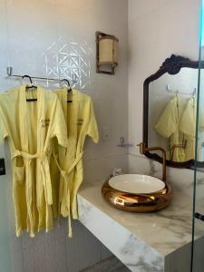 a bathroom with a sink and a toilet on a counter at Village as casinhas in Uruçuca +78 photos
