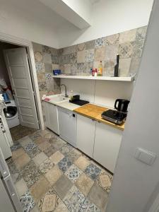 a small kitchen with a sink and a counter at Hotel Campo Pequeno in Lisbon