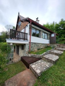 a house with a porch and stairs in front of it at Chalupa Dolce Vita in Trutnov