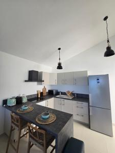 a kitchen with a table and two chairs and a counter at Villa Aura in Oyster Pond +28 photos