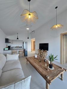 a living room with a couch and a table at Villa Aura in Oyster Pond
