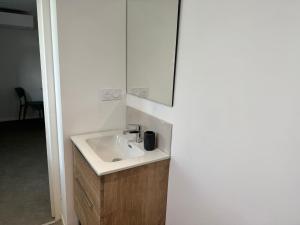a bathroom with a sink and a mirror at Logis Le Pagnon in Brive-la-Gaillarde