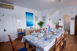 a dining room with a table and chairs at Villa El Capricho in Mijas
