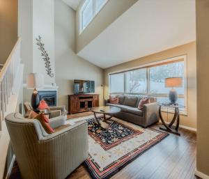 a living room with two couches and a table at Meadow Lake Townhouse For 6ppl in Columbia Falls