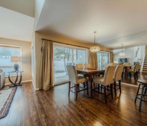 a dining room and living room with a table and chairs at Meadow Lake Townhouse For 6ppl in Columbia Falls