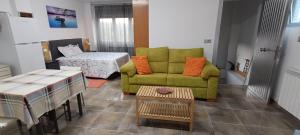 a living room with a green couch and a table at MariaS Vacation Rental in Obregón