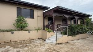 a house with a staircase in front of it at Blissfull Corner at Centerpoint Unit 1 in Suva