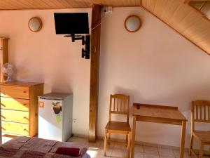 a bedroom with a bed and a tv on the wall at Rybářská bašta-Vikletice in Kwon
