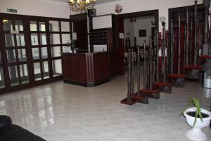 a lobby with a row of stairs in a building at Karikas Hotel in Hajdúszoboszló