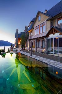 a large pool of water in front of a house at Chateau Okanagan in Kelowna