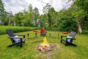 three chairs and a fire pit in a yard at Havenwood in Logan