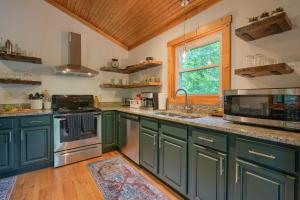 a kitchen with green cabinets and a window at Havenwood in Logan