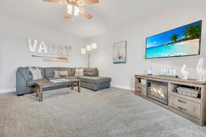 a living room with a couch and a tv at The Retreats at Stone Fountain in Arnolds Park