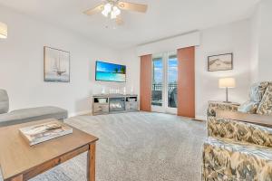 a living room with a couch and a table at The Retreats at Stone Fountain in Arnolds Park +18 photos