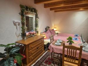 a living room with a table and a mirror at Sonnleit'n Zimmer 7 in Abtenau