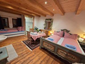 a bedroom with a bed and a table and a couch at Sonnleit'n Zimmer 7 in Abtenau +67 photos