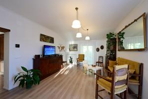 a living room with a television and a dining room at Domus Aromatica in Assisi