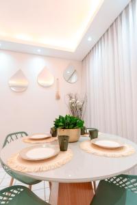 a white dining room with a white table and chairs at REFÚGIO FAMILIAR Jampa JP in João Pessoa