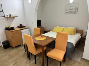 a bedroom with a bed and a table and chairs at Apartments Ozren in Soko Banja