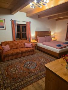 a living room with two beds and a couch at Sonnleit'n Zimmer 6 in Abtenau