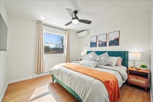 a bedroom with a bed and a ceiling fan at Cozy Pocono Retreat in Tobyhanna +41 photos