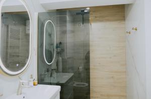 a bathroom with a sink and a shower at Apartman Djurić in Brčko