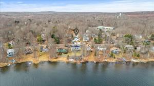 an aerial view of a house on an island in the water at Cozy Pocono Retreat in Tobyhanna