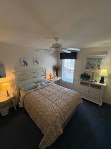 a bedroom with a bed and a ceiling fan at Spacious Home Bethany Beach in Frankford +17 photos