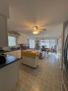 a large kitchen with a ceiling fan and a table at Spacious Home Bethany Beach in Frankford