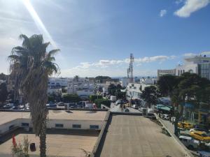 a view of a city with a palm tree at L'Ambre in Hammamet