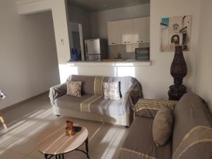 a living room with a couch and a table at L'Ambre in Hammamet