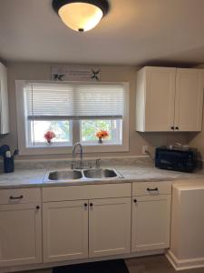 a kitchen with a sink and a window at Skipper Apt #4 in Rockingham +4 photos