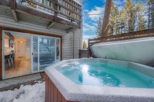 a jacuzzi tub in the backyard of a house at Zephyr Chalet Steps from Zephyr Cove in Glenbrook