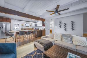 a living room and kitchen with a couch and a ceiling fan at Zephyr Chalet Steps from Zephyr Cove in Glenbrook